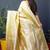 Lemon yellow banarasi silk blend saree with floral jaal & zari border
