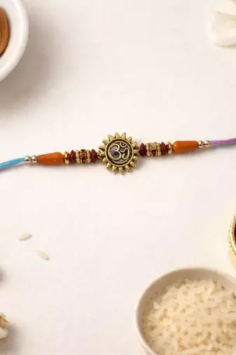gold plated om designer rakhi with roli chawal & raksha bandhan card