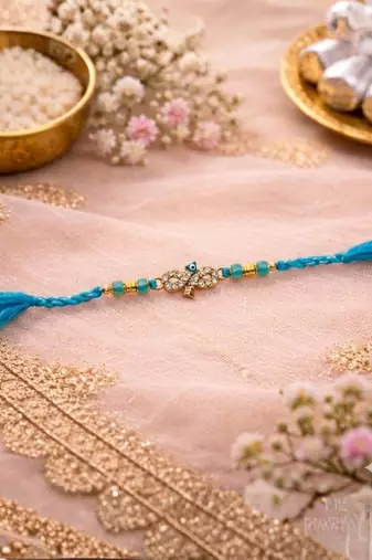 evil eye designer rakhi for brother with roli chawal & raksha bandhan card