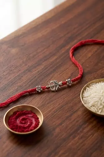 om trishul charm thread rakhi with roli chawal & rakshabandhan card