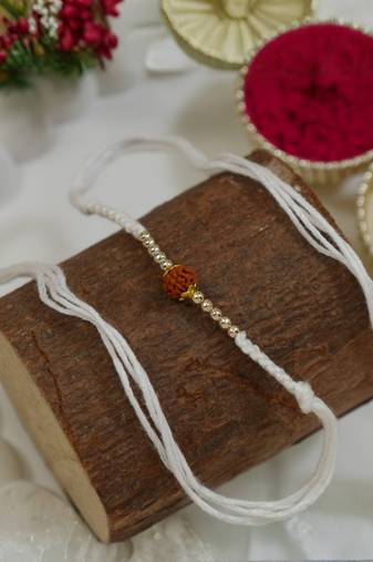 traditional rudraksha rakhi with roli chawal and raksha bandhan card