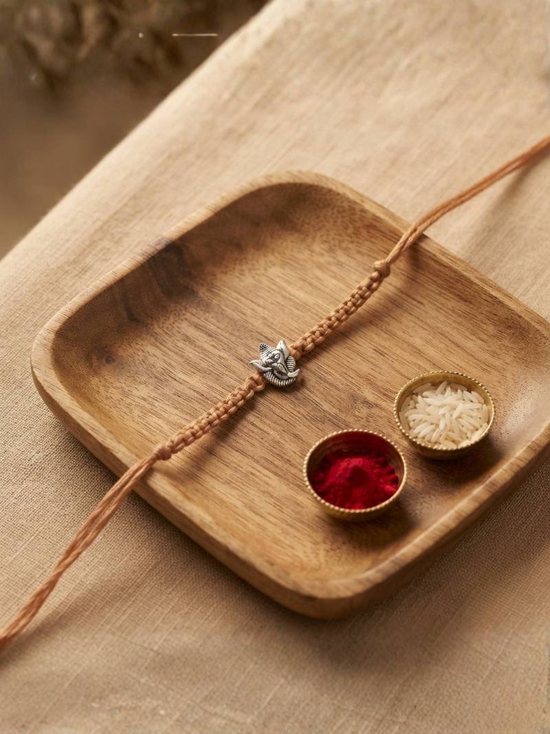 ganesha designer rakhi with roli chawal and raksha bandhan card