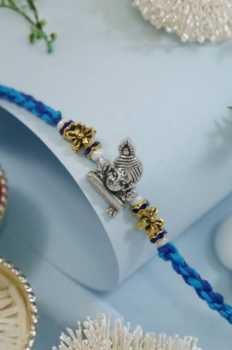 ganesha designer blue rakhi with roli chawal and raksha bandhan card