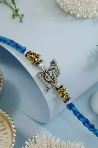 ganesha designer blue rakhi with roli chawal and raksha bandhan card