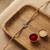 ganesha design rakhi with roli chawal and raksha bandhan card