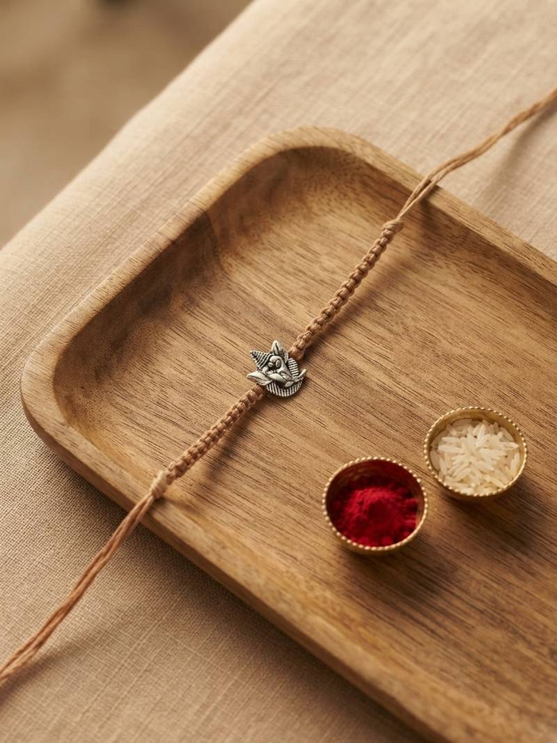 ganesha design rakhi with roli chawal and raksha bandhan card