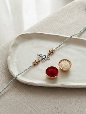ganesha design rakhi with roli chawal and raksha bandhan card 1