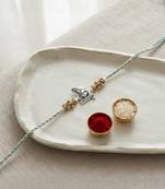 ganesha design rakhi with roli chawal and raksha bandhan card