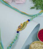 peacock feather designer rakhi with roli chawal and raksha bandhan card