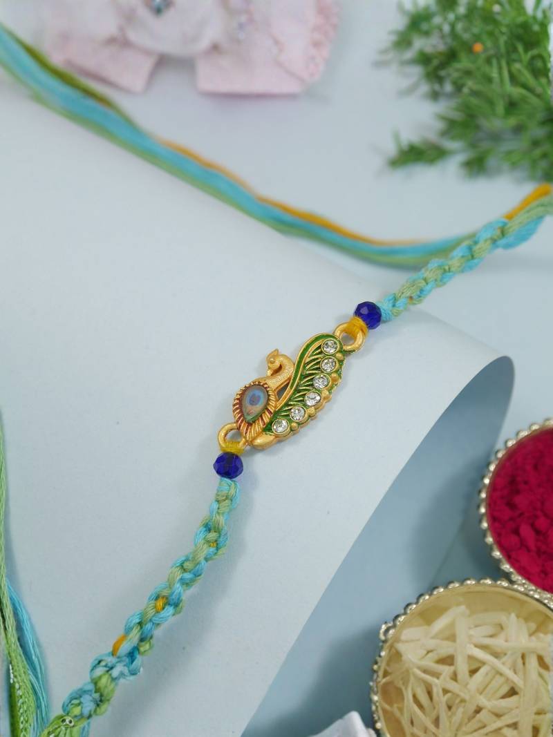 peacock feather designer rakhi with roli chawal and raksha bandhan card