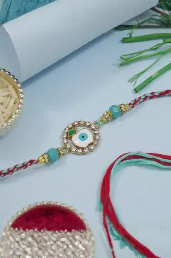evil eye designer rakhi with roli chawal and raksha bandhan card