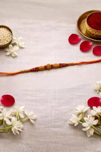 wooden bead designer rakhi with roli chawal and raksha bandhan card