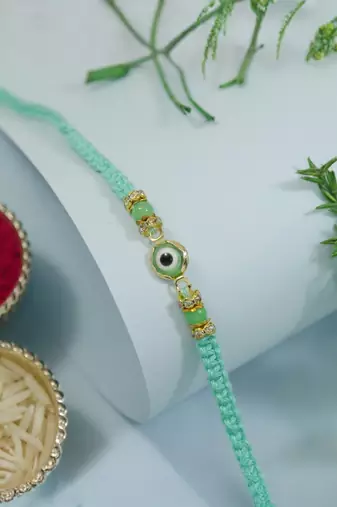 evil eye designer rakhi with roli chawal and raksha bandhan card