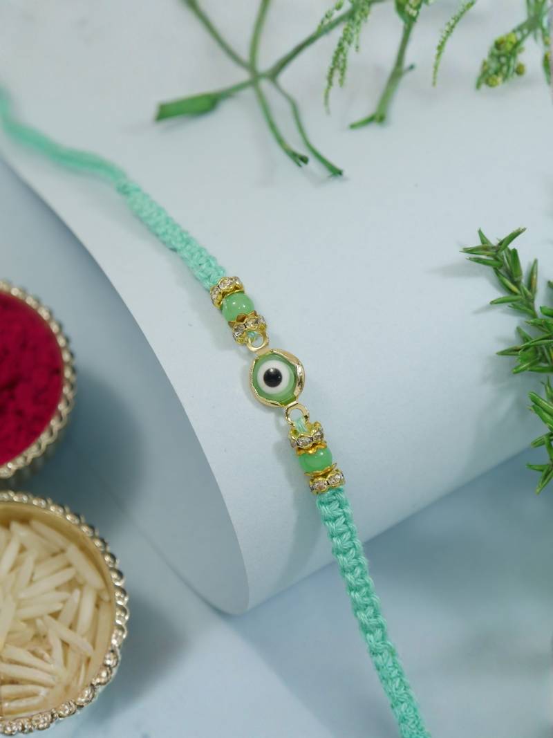 evil eye designer rakhi with roli chawal and raksha bandhan card
