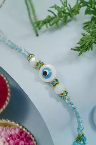 evil eye theme designer rakhi with roli chawal and raksha bandhan card
