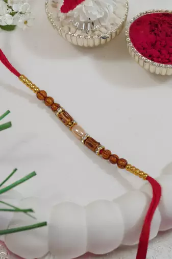 beaded design rakhi with roli chawal and raksha bandhan card