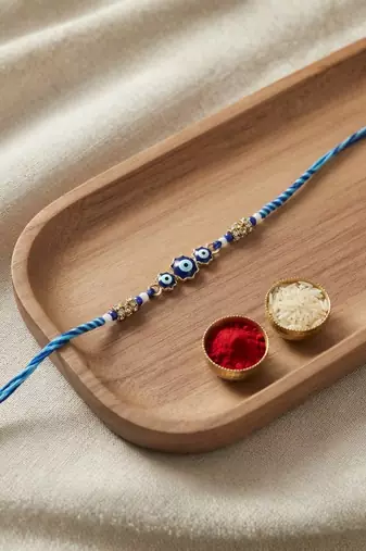 evil eye theme designer rakhi with roli chawal and raksha bandhan card