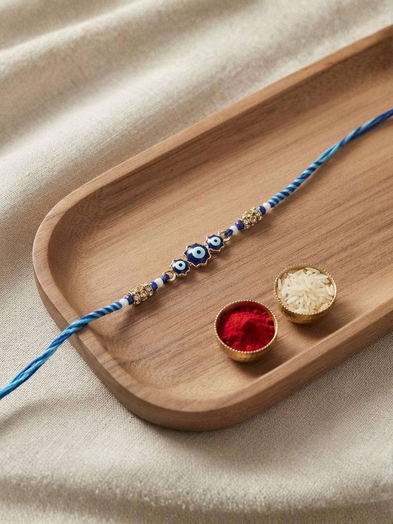 evil eye theme designer rakhi with roli chawal and raksha bandhan card