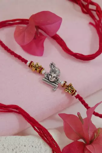 krishna designer red rakhi with roli chawal and raksha bandhan card