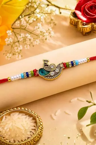 peacock designer red rakhi with roli chawal and raksha bandhan card