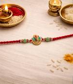 ganesha designer red rakhi with roli chawal and raksha bandhan card