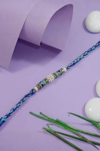 designer blue rakhi with roli chawal and raksha bandhan cards