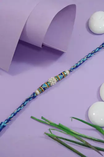 designer blue rakhi with roli chawal and raksha bandhan cards