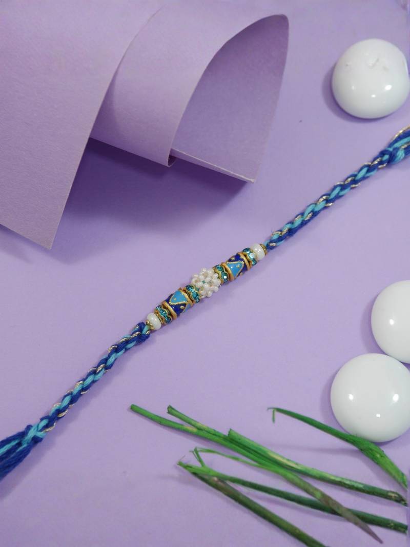 designer blue rakhi with roli chawal and raksha bandhan cards
