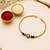 Luxury crystal rakhi with red & green beads for raksha bandhan