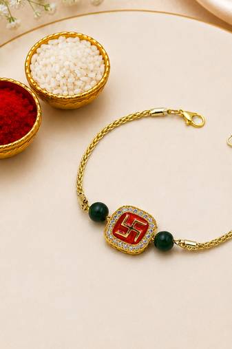 Gold-tone swastik designer rakhi with green beads