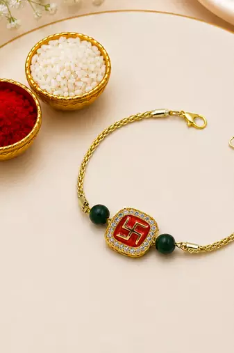 Gold-tone swastik designer rakhi with green beads