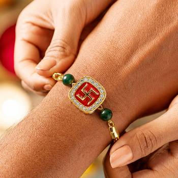 Gold-tone swastik designer rakhi with green beads 3