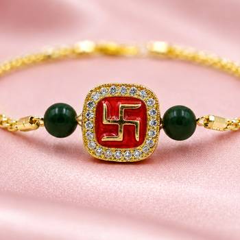 Gold-tone swastik designer rakhi with green beads 4