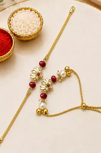 Gold-plated lotus bhaiya bhabhi rakhi set with red beads