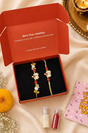 Gold-plated lotus bhaiya bhabhi rakhi set with red beads