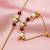 Gold-plated lotus bhaiya bhabhi rakhi set with red beads