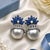 Rhodium finish sapphire and pearl ad earrings