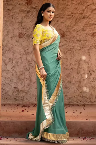 Sage green embroidered pure georgette saree