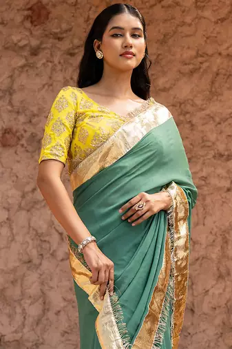 Sage green embroidered pure georgette saree