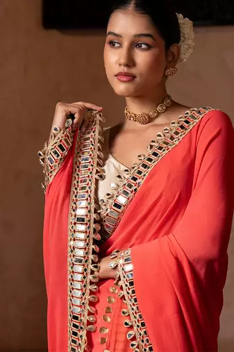 Coral orange embroidered pure georgette saree