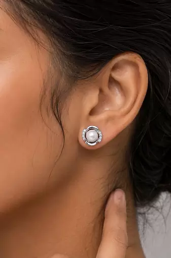 Silver color american diamond earrings with designer finish