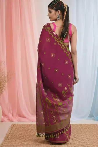 magenta cotton blend saree with traditional woven patterns and tassel border