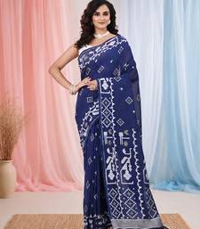 navy blue cotton blend saree with traditional woven patterns and tassel border