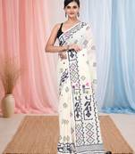 off white cotton blend saree with traditional woven patterns and tassel border