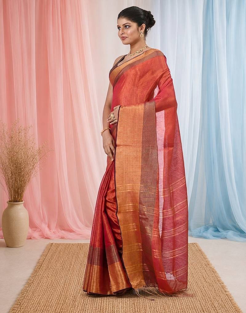 Elegant red tissue saree with contrasting golden border