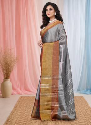 Elegant grey tissue saree with contrasting golden border 2