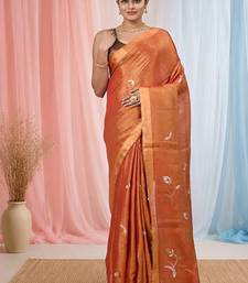 Orange tissue saree with ethnic motifs and golden border
