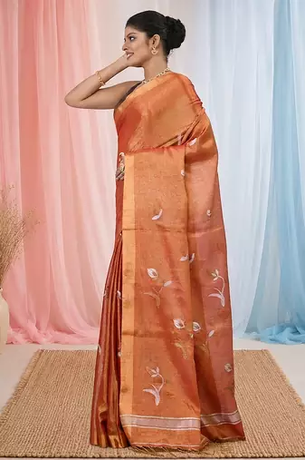 Orange tissue saree with ethnic motifs and golden border
