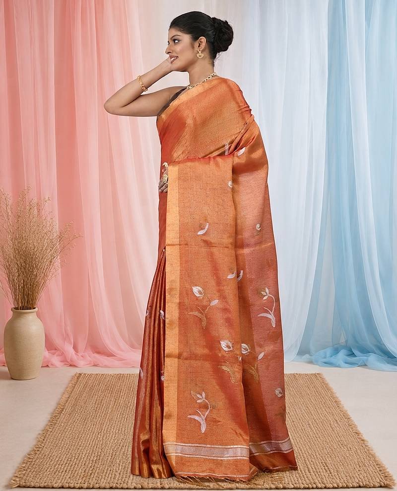 Orange tissue saree with ethnic motifs and golden border
