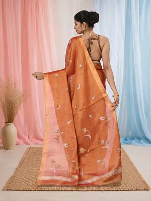 Orange tissue saree with ethnic motifs and golden border 3